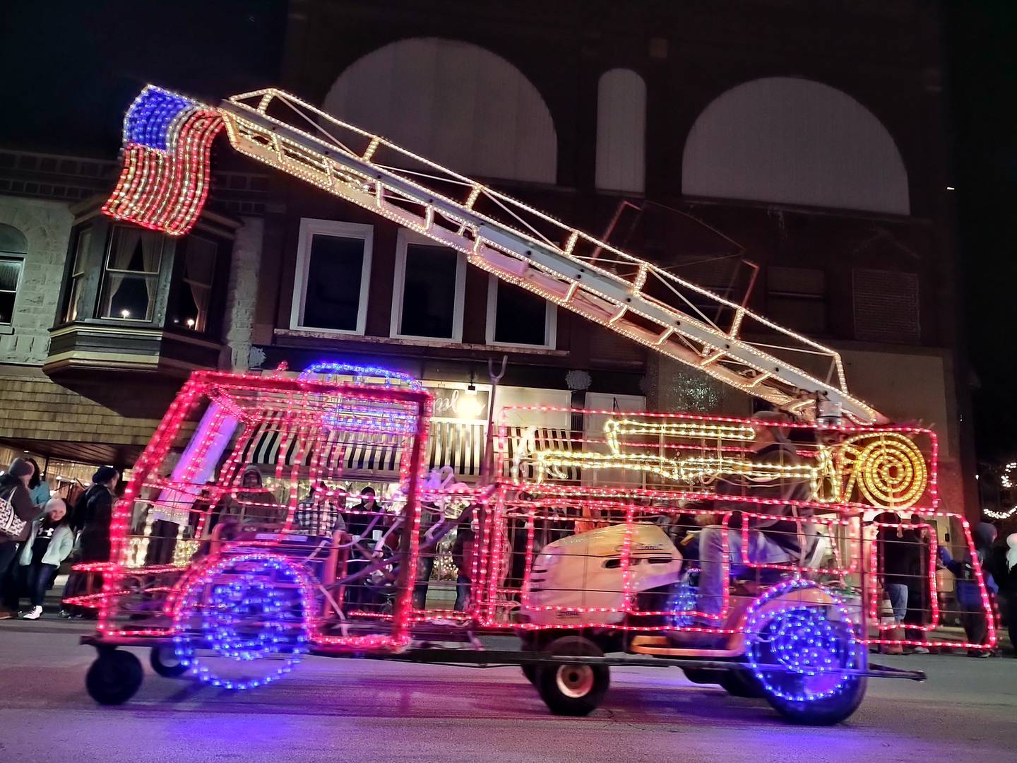 A lighted firetruck cruises Saturday, Nov. 27, 2021, through the Keeping Christmas Close to Home's Lighted Parade in downtown Streator.