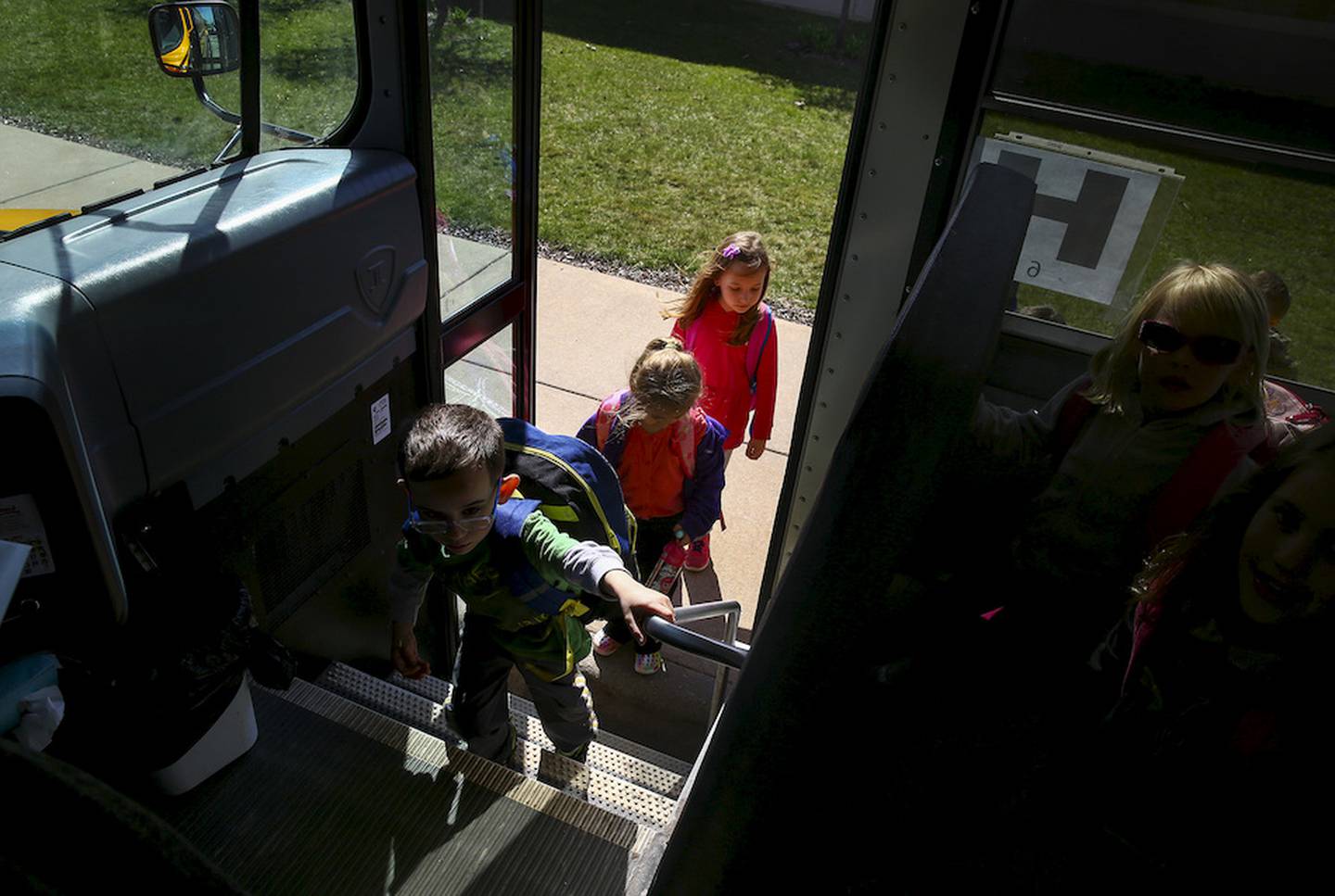 Students from Manhattan School District 114 Elementary board a Lincoln-Way Community High School bus Wednesday in Manhattan.
