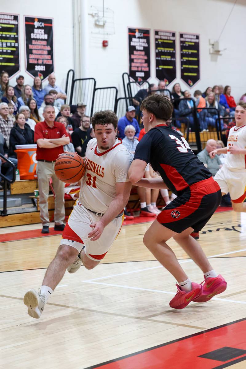 St. Anne's Brandon Schoth drives against Momence's Jackson Ford during St. Anne's 64-43 victory in the River Valley Conference semifinals on Tuesday, Feb. 10, 2026.