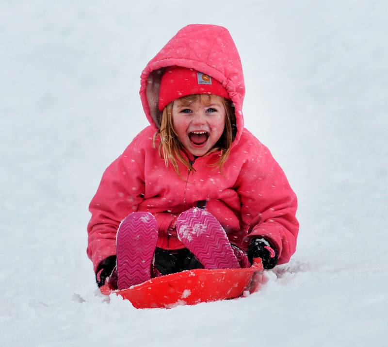 Layla Mason, 5, of Oregon, yells as she slides down the sledding hill at Oregon Park West on Friday, Jan.12, 2024. Friday's snowstorm brought more than 6 inches of snow to Ogle County by late afternoon creating difficult driving conditions for motorists, but plenty of fun for kids.