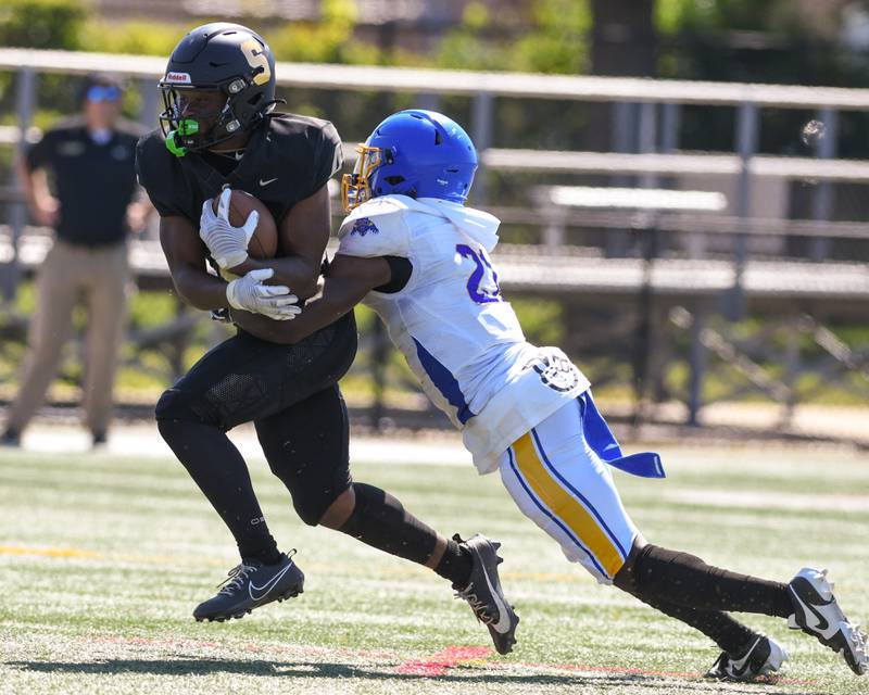 Simeon Dewayne Brooks, right, takes down Sycamore Tyler Curtis (4) during the first quarter on Saturday Sep. 2, 2023, held at Gately Stadium in Chicago.
