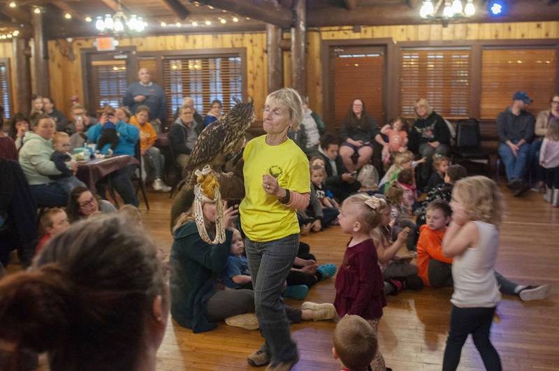 Karen Herdklotz, owner and founder of Hoo Haven, lets a group of visitors at White Pines Resort get a close look at Denver, a eurasian eagle-owl that was rescued by the animal rehabilitation facility. The non-profit organization held a program Wednesday, April 13, 2022 at the resort in order to introduce the animals and their mission to kids and families.