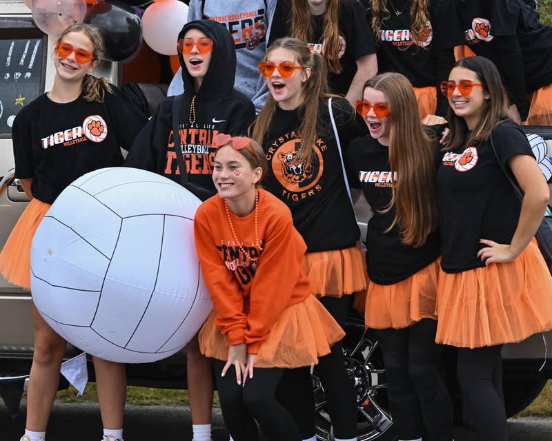 The Crystal Lake Central H.S. girls JV volleyball team poses for photos at the start of their 100 year anniversary homecoming day parade on Saturday, Sep. 16, 2023 in Crystal Lake. The parade began at the high school and made its way through downtown Crystal Lake.