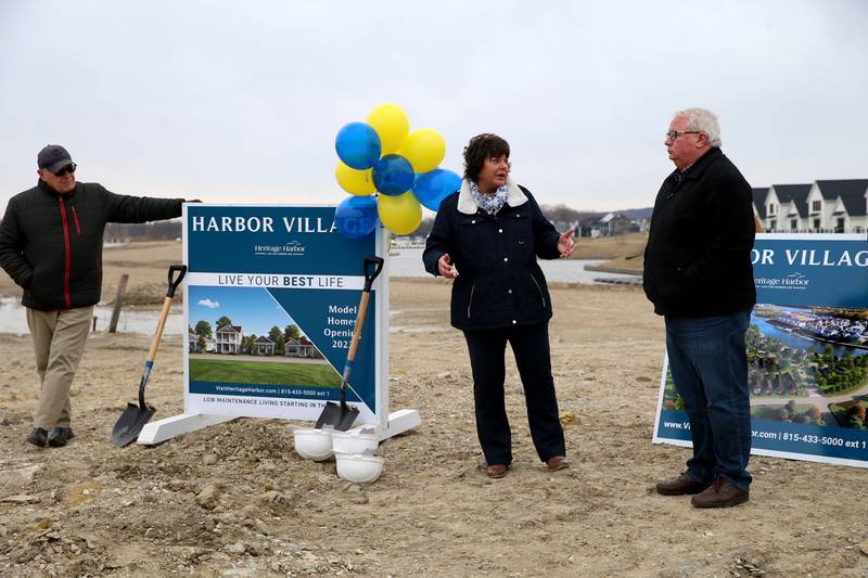 Tom Heimsoth, developer for Heritage Harbor, Tammy Barry, vice president of sales and marketing and Ottawa Mayor Dan Aussem chat about the groundbreaking of the new Harbor Village neighborhood on Thursday, March 9, 2023 at Heritage Harbor in Ottawa. The neighborhood will begin building three of the six low-maintenance homes and expect them to be a big draw for the active adult community.