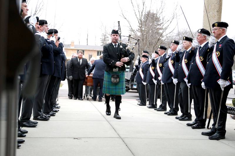 Bagpiper Dave Johnston leads the casket of Reverend Jonathan Bakkelund for the Mass of Christian Burial at St. Peter Catholic Church in Geneva on Wednesday, Jan. 31, 2024.