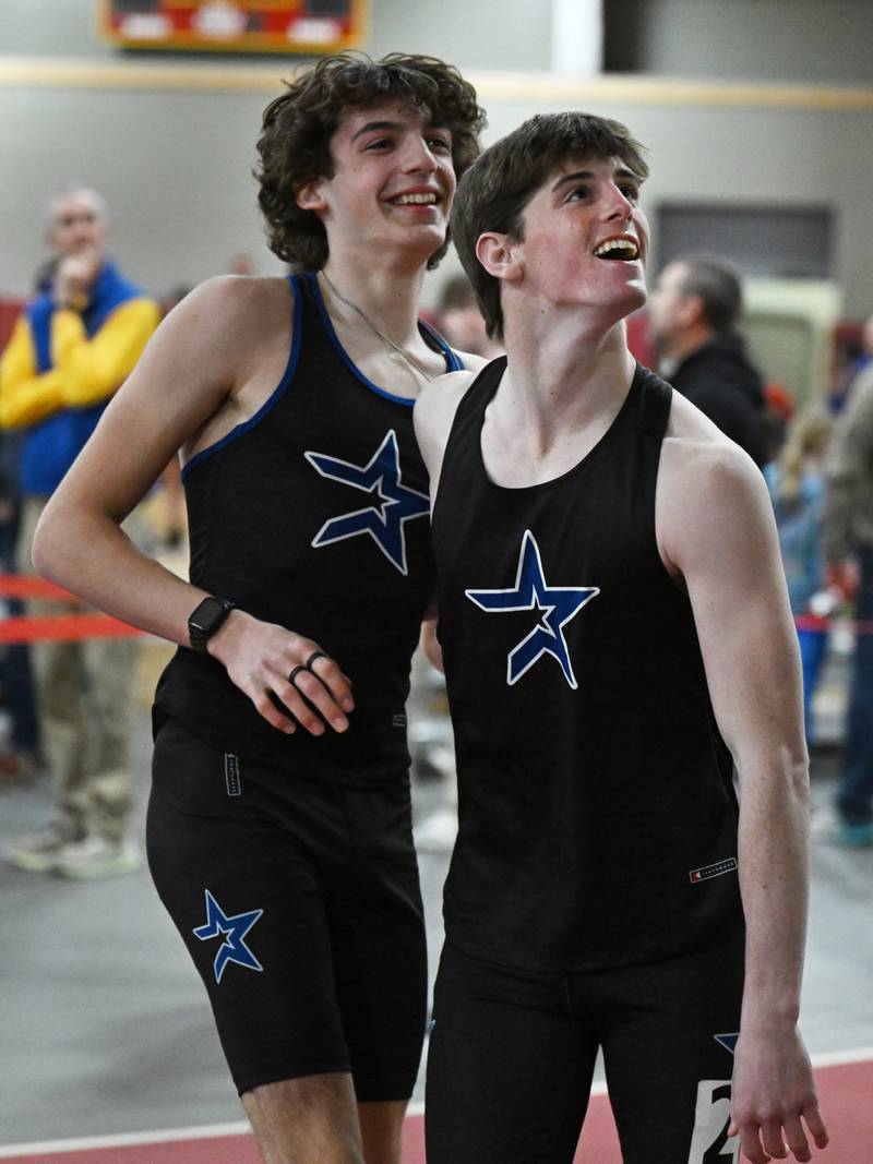 St. Charles North’s Brogan Sons, right, celebrates his first-place finish in the 55-meter hurdles alongside teammate Bryson Boscaljon during the DuKane Conference indoor track meet at Batavia High School on Friday, March 21, 2025.