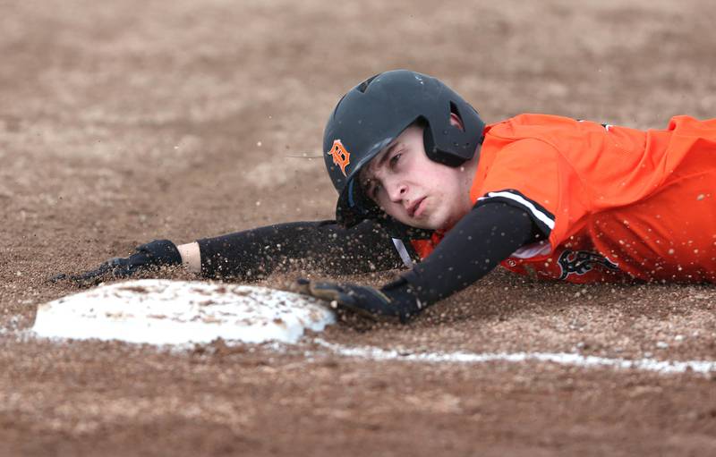 DeKalb's Julius Montavon slides safely into third during their game against Jefferson Wednesday, April 6, 2022, at DeKalb High School.
