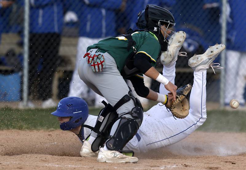 Burlington Central’s Brady Gilroy slides into home in front of the throw to Crystal Lake South's Tony Amici during a Fox Valley Conference baseball game on Friday, April 12, 2024, at Burlington Central High School.