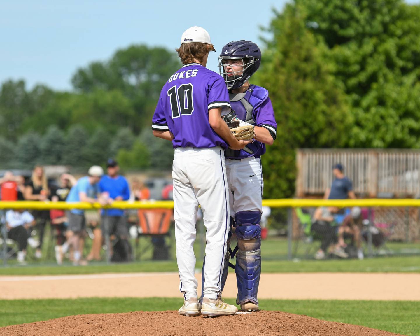 Dixon pitcher Bryce Fiet (10) talks to catcher Beau Evans during a mound visit on June 1st during a sectional play off game held in Sycamore.