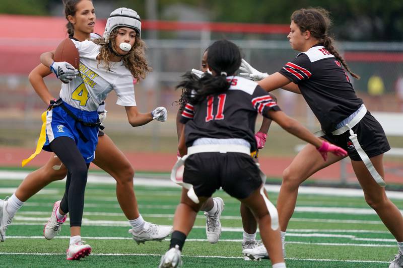Joliet Central's Brianna Lenoir (4) runs after the catch against Yorkville during a flag football game at Yorkville High School on Monday, Sep 23, 2024.
