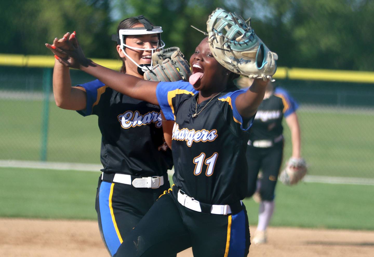 Aurora Central Catholic’s Maddy Torrance, left, and Ashley Moore celebrate an out against Marengo in IHSA Class 2A Regional Title Game action softball at Marengo High School in Marengo on Friday, May 23, 2025.