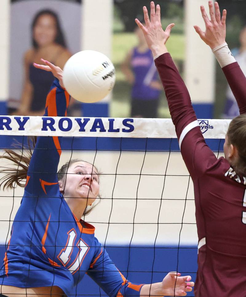 Genoa-Kingston's Lily Mueller spikes the ball by Marengo's Gianna Almeida Thursday, Oct. 27, 2022, during their Class 2A Regional final match at Rosary High School in Aurora.