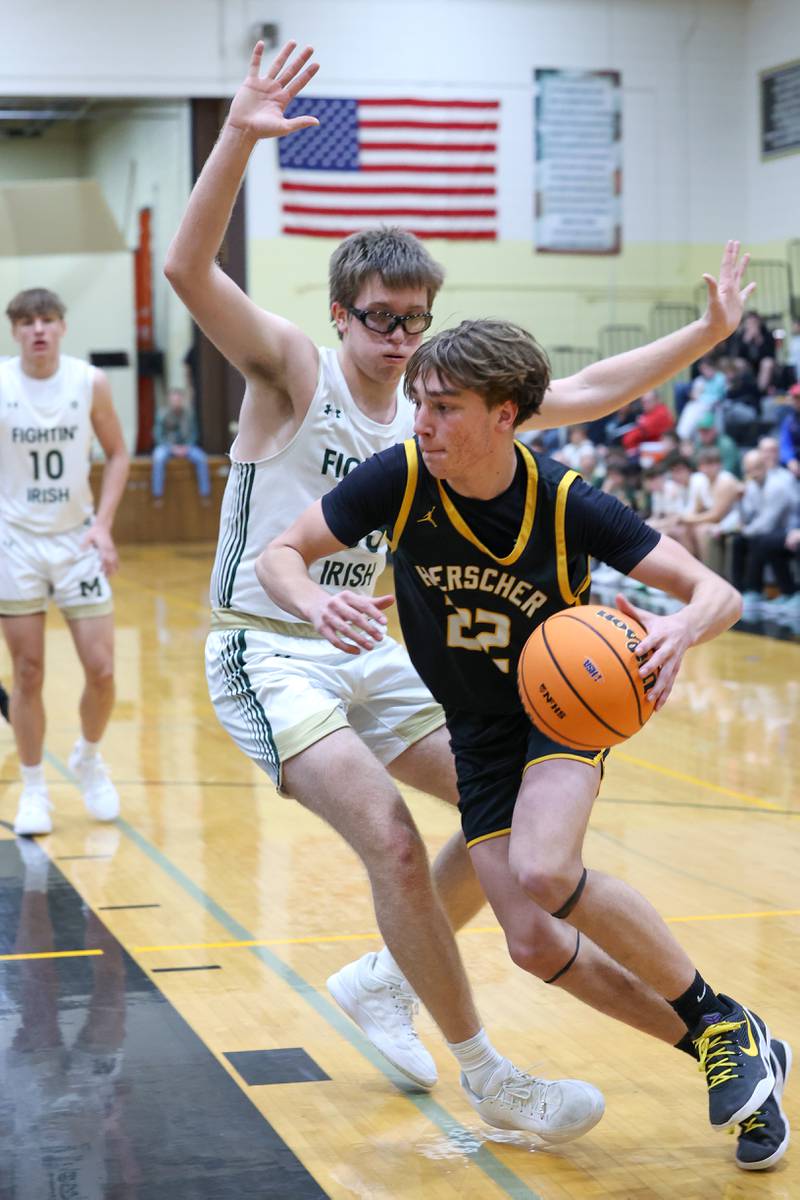 Bishop McNamara's Callaghan O'Connor defends a drive by Herscher's Tyler Lundberg during Bishop McNamara's 71-42 victory in the IHSA Class 2A Herscher Regional semifinal on Wednesday, Feb. 25, 2026.