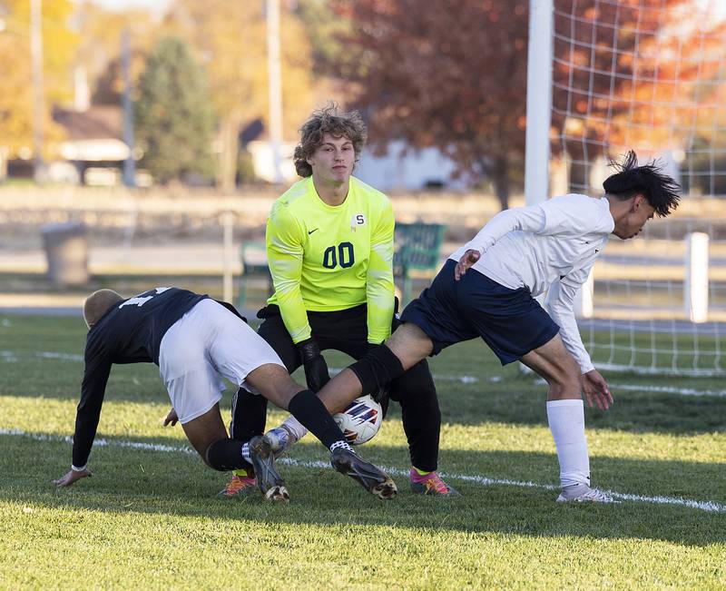 Sterling goalie Rex Blackburn stops the ball as teammate Billy Sullivan (right) and Dunlap’s Yash Kulkarni crash the net Wednesday, Oct. 23, 2024, during the class 2A soccer regional semifinal in Geneseo.