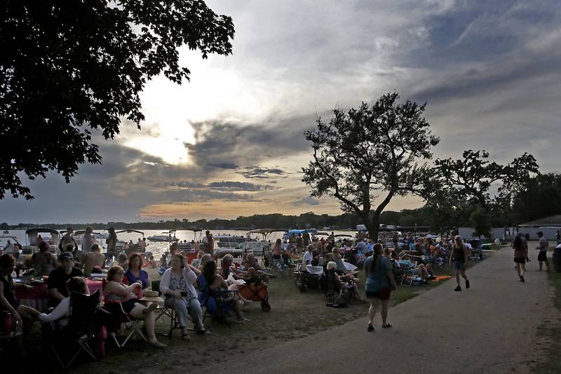 People listen to the music of Serendipity sing during the Crystal Lake Park District's Concert in the Park on Tuesday, June 17, 2025, at Main Beach in Crystal Lake. The concert was part of the park district's weekly Tuesday night summer concert series.