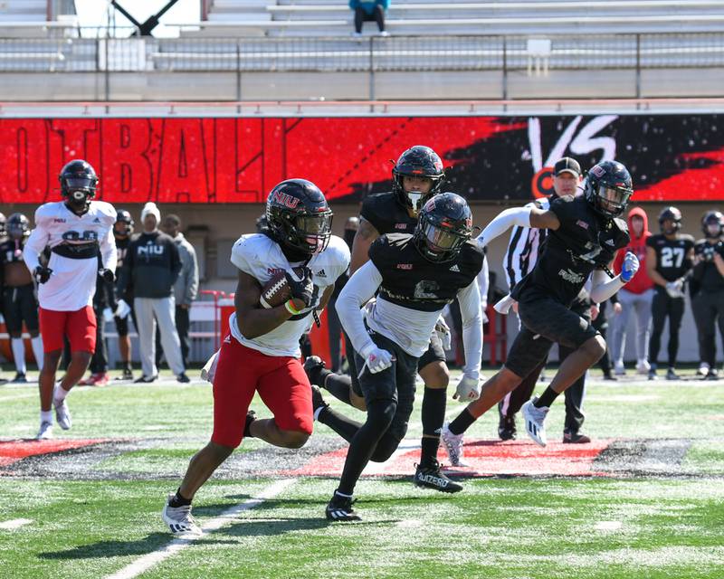 Northern Illinois University wide receiver Billy Dozier,center, gains some yards during the spring scrimmage at Huskie Stadium held on Saturday April 16th.