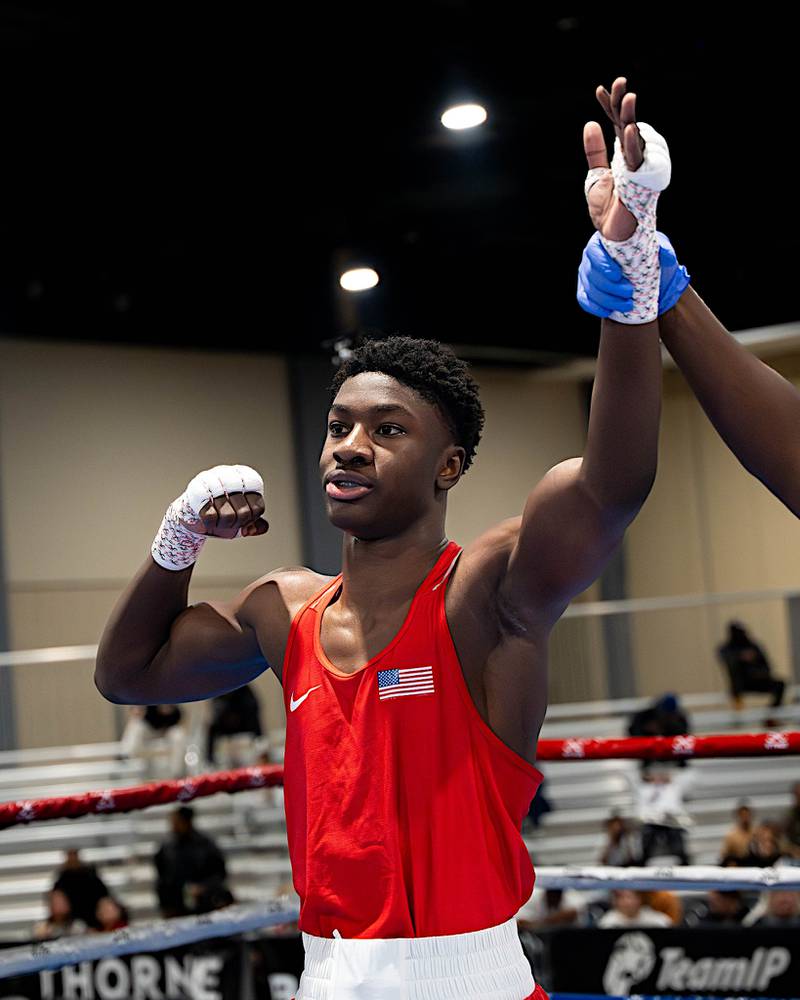 Joliet's JoJo Awinongya gets his hand raised in triumph after winning the 176-pound Youth Division title at the USA Boxing National Championships.