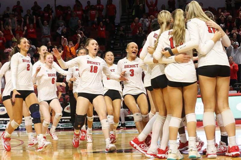 Members of the Benet Academy volleyball team celebrate after defeating Huntley during the Class 4A State semifinal game on Friday, Nov. 15, 2024 at CEFCU Arena in Normal.