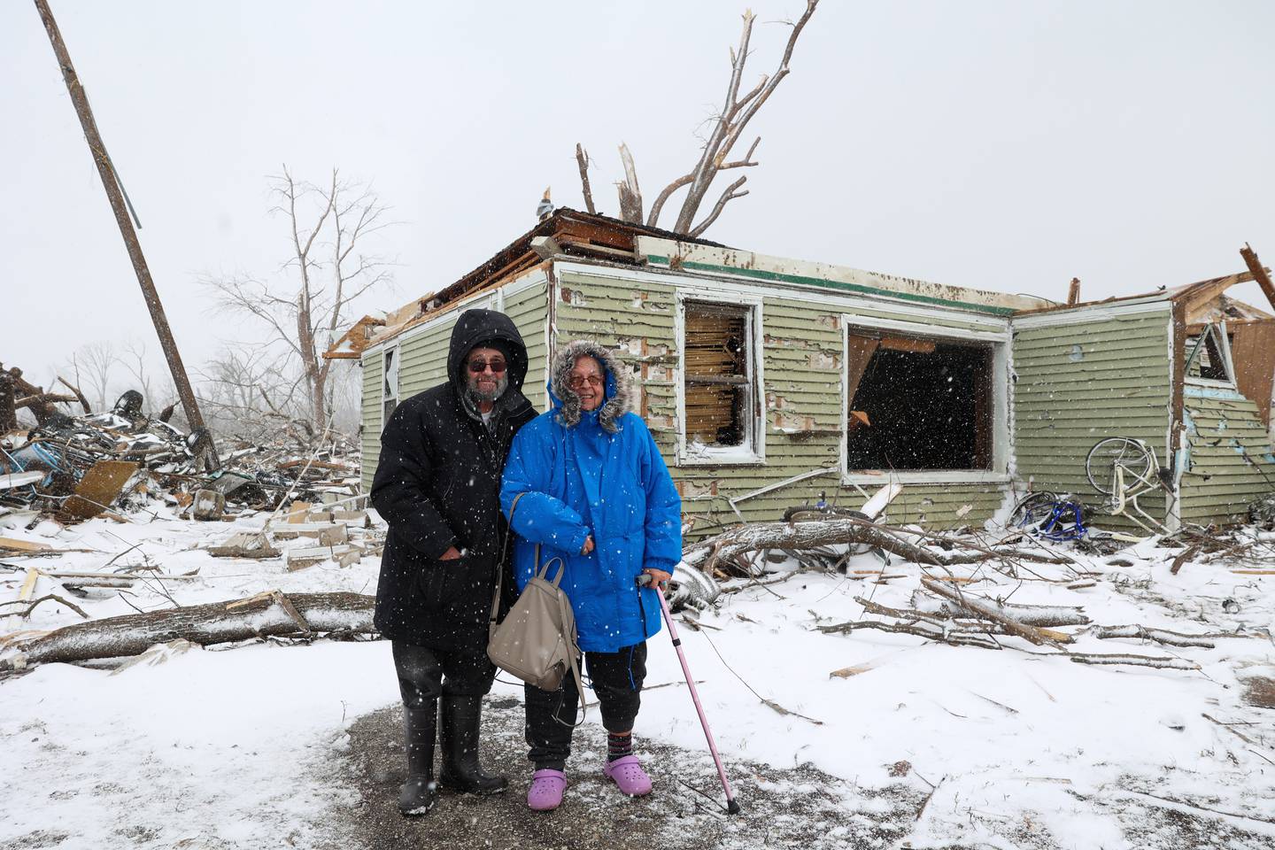 Evanston residents Douglas Weber and Martha Plaza-Weber stand outside what was once their summer home along South Sandbar Road in Aroma Township on March 16, 2026, following the March 10 tornado in Kankakee County. The couple had left earlier in the week after planning their garden, and said they luckily were not at the home when the storm came through.