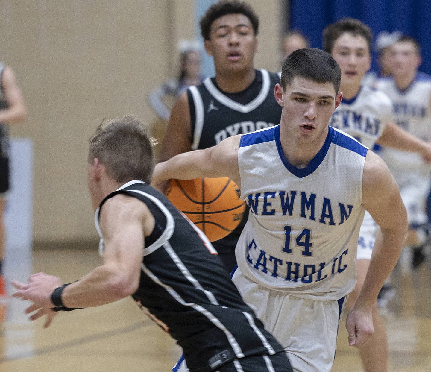 Newman’s Renner Rosengren handles the ball against Byron’s JJ Edmonson Tuesday, Dec. 3, 2024, at Newman High School.