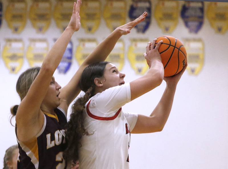 Huntley's Paula Strzelecki is fouled by Loyola Academy's Grace Bronski during the IHSA Class 4A Gurnee Warren Supersectional girls basketball game on Monday, March 3, 2025, at Warren Township High School in Gurnee.