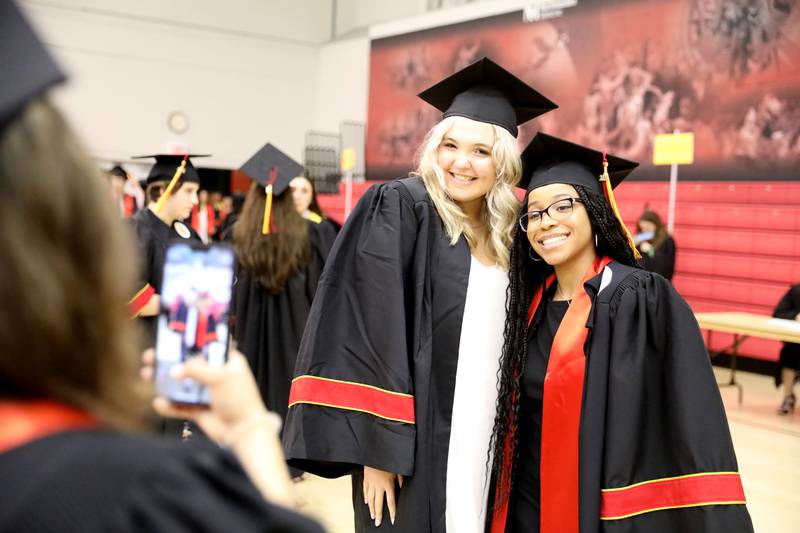 Graduates Ella Helfer (left) and Kristina Baker pose for a photo before the 2022 Batavia High School Commencement Ceremony at the Northern Illinois University Convocation Center in DeKalb on Wednesday, May 25, 2022.