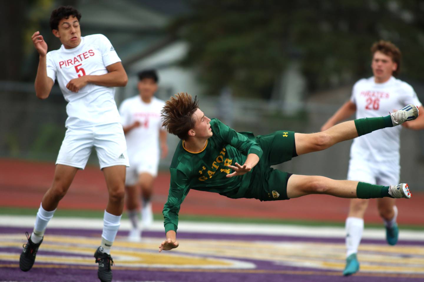 Crystal Lake South’s Ethan Nawracaj, right, goes airborne on a shot on goal as Palatine’s Adam Adame, left, reacts in varsity boys soccer at Ray Porten Field on the campus of Wauconda High School in Wauconda on Wednesday, Sept. 3, 2025.