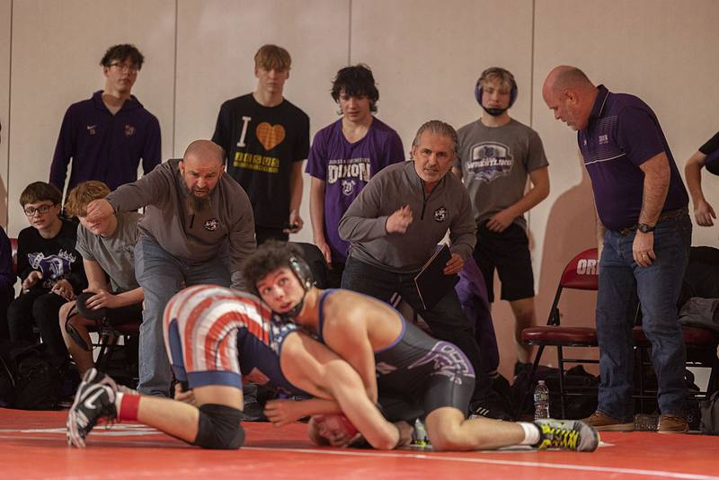 Dixon coaches yell advice to Preston Richards as he grapples with Morrison’s Mason Grismore in the 150 pound weight class in the Class 1A wrestling sectionals at Oregon.