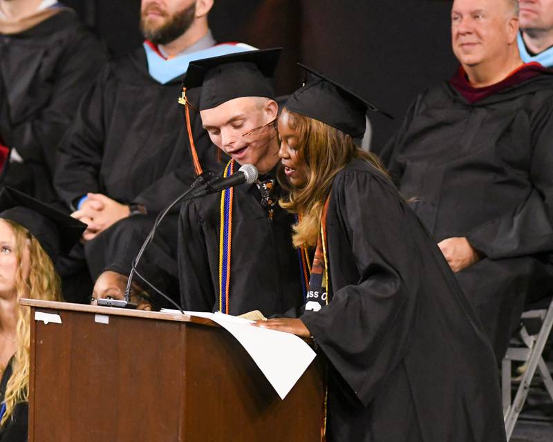DeKalb High School seniors Nolan Knutson and Zora Watts introduce their principal, Donna Larson, to speak during the graduation ceremony on Saturday, May 23, 2026, held at the Convocation Center in DeKalb.