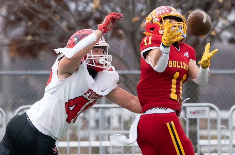 Batavia’s Gerke Drew (11) intercepts a pass intended for Yorkville's Blake Kersting (40) during a 7A quarterfinal playoff football game at Batavia High School on Saturday, Nov 12, 2022.