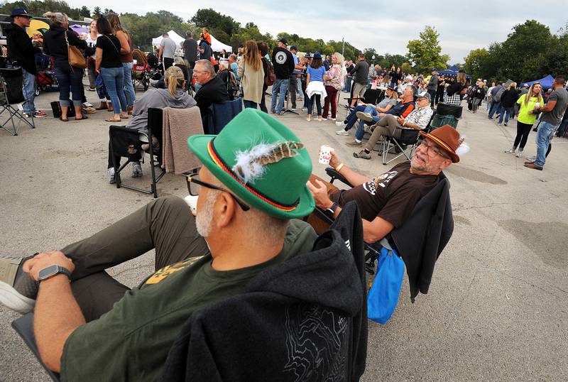 Donning Tyrolean hats, friends Rob and Jim enjoy the music and beer during Yorktoberfest, Saturday, Sept. 28, 2024, in Riverfront Park in Yorkville.