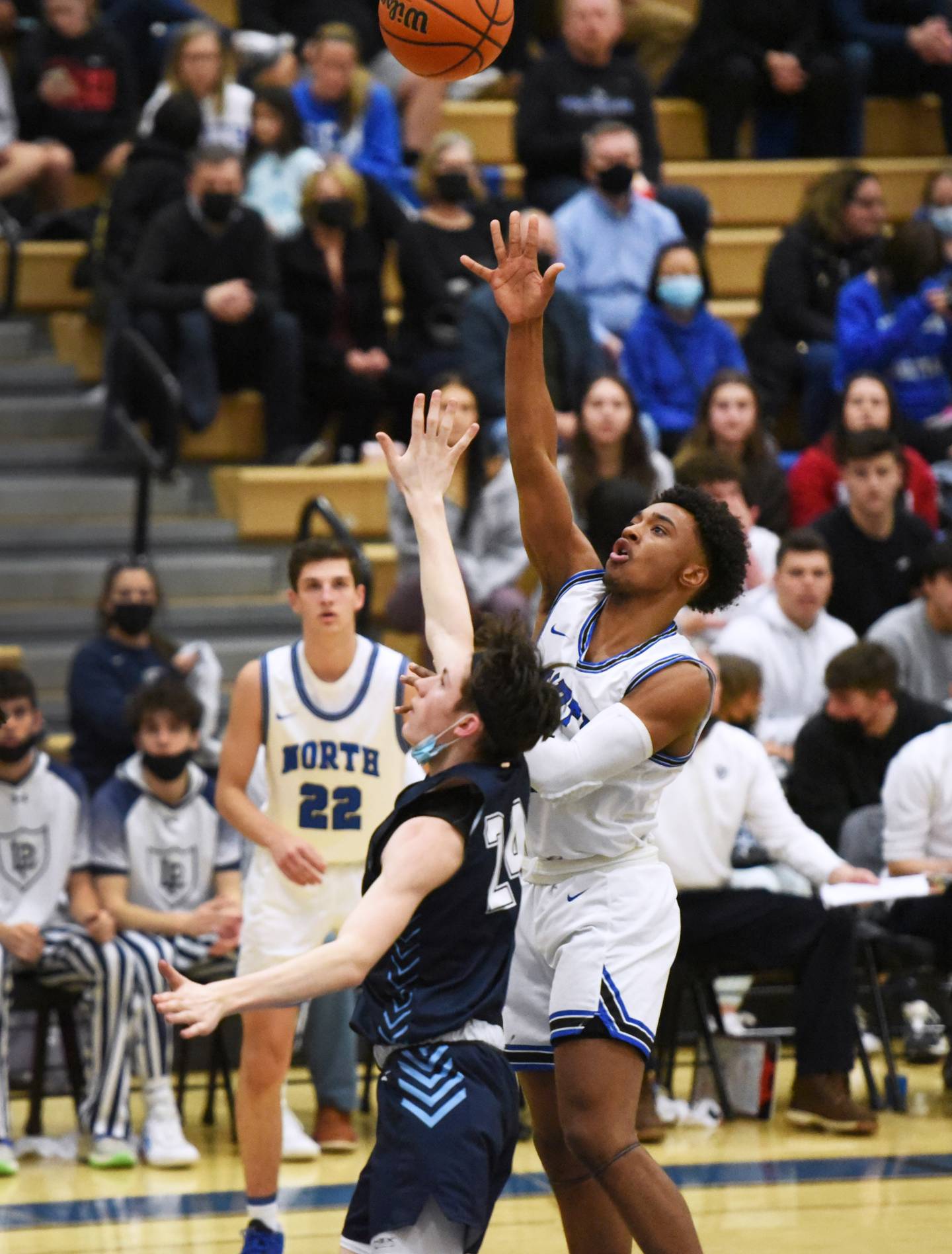 St. Charles North's Tajuan Pinex takes a shot over Lake Park's Camden Cerese (24) during Tuesday's boys basketball game in St. Charles.