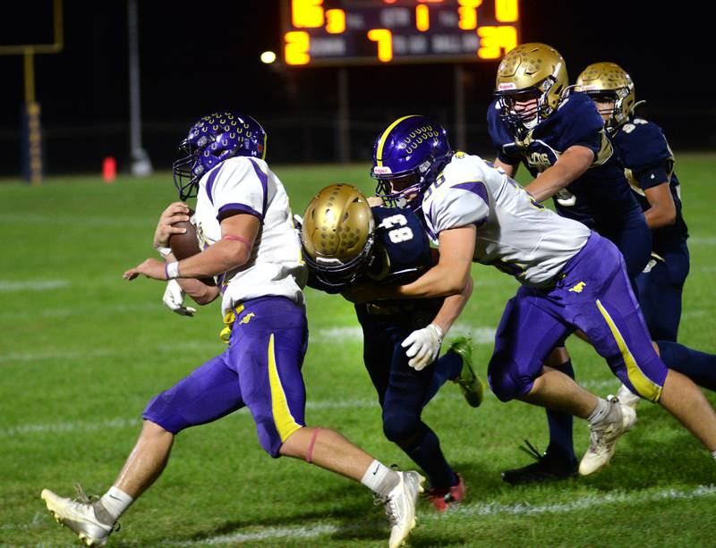 Polo's Mercer Mumford (83) tackles an Orangeville player at Polo High School on Friday, Oct. 3, 2025