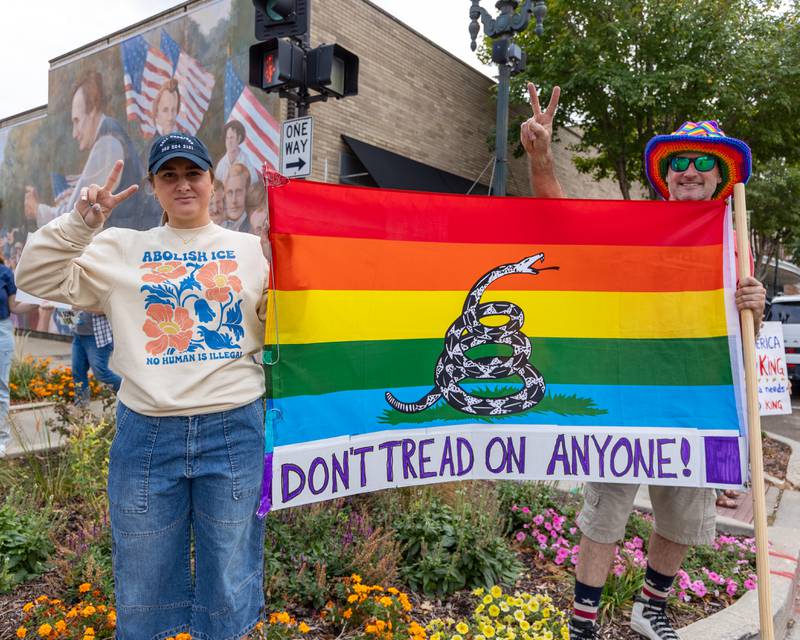 Protesters hold flag at the ‘No Kings 2.0’ Protest on Saturday, October 18, 2025 at Washington Square Park in Ottawa.