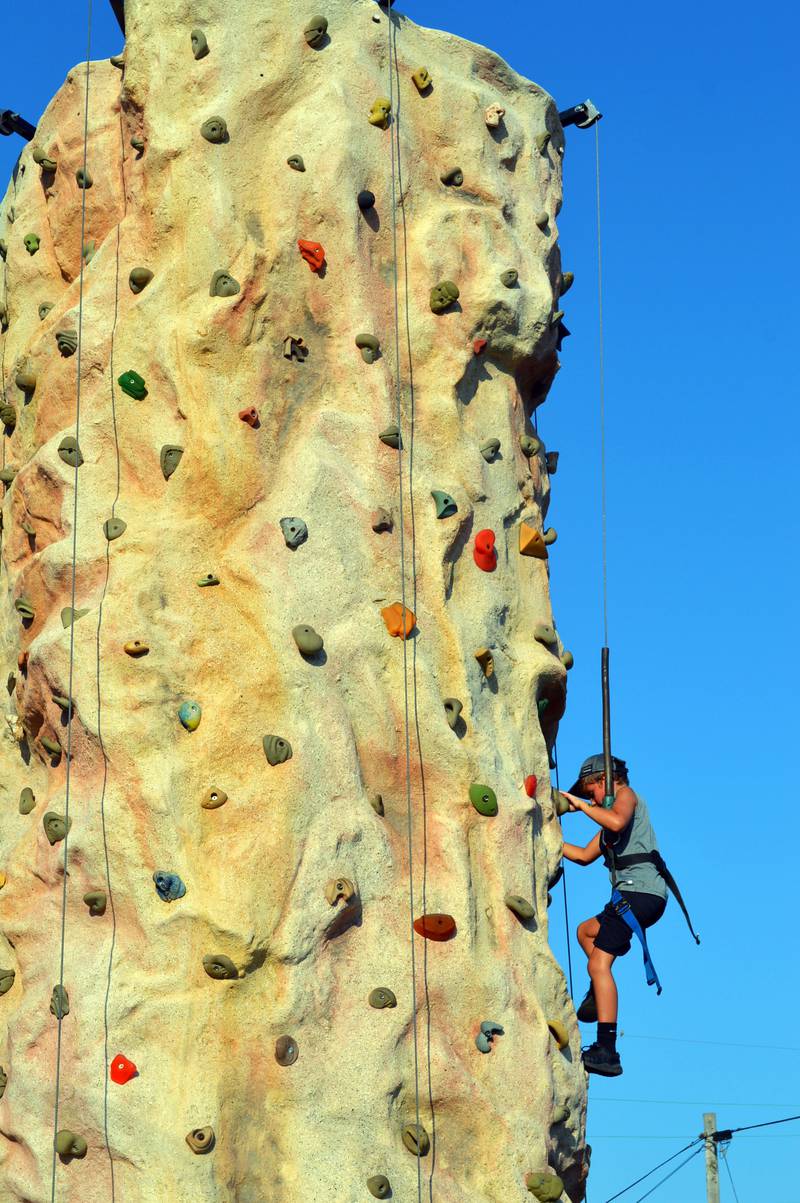 Jon Clark, 8, of Forreston climbs a rock wall on Friday, Aug. 2, 2024, at Forreston Sauerkraut Days.