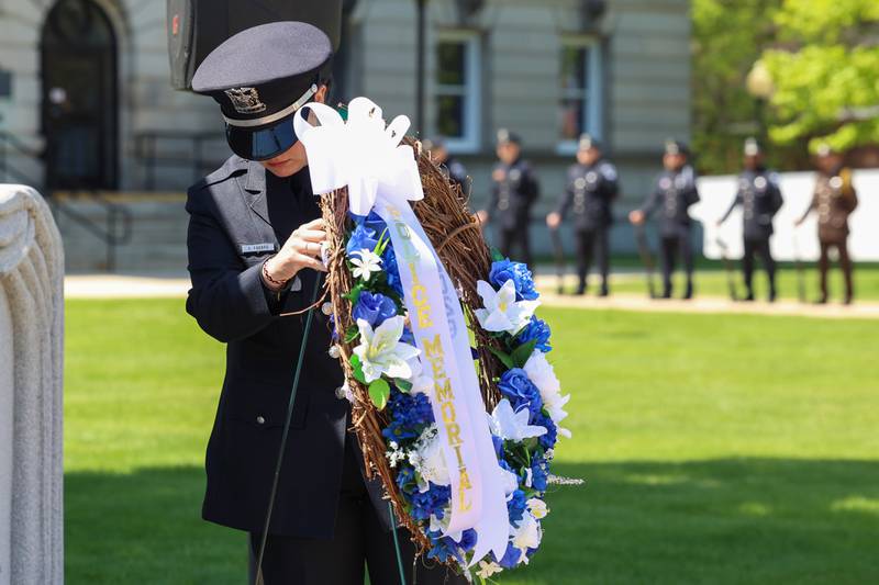 Kankakee Police Officer Samantha Fabbro places the wreath at the memorial wall during the Kankakee County Law Enforcement Memorial on Thursday, May 14, 2026, at the Kankakee County Courthouse.