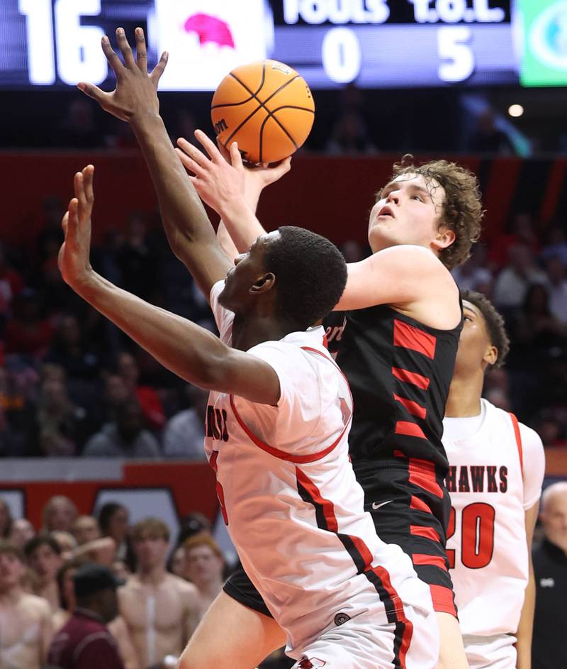 Benet's Ethan MacDermot goes to the basket against Marist's Stephen Brown Saturday, March 14, 2026, during their IHSA Class 4A state championship game in the State Farm Center at the University of Illinois in Champaign.