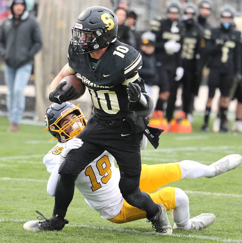 Sycamore's Zack Crawford is brought down by Sterling's Mason Emin inches from the goal line during their Class 5A state playoff game Saturday, Nov. 12, 2022, at Sycamore High School.