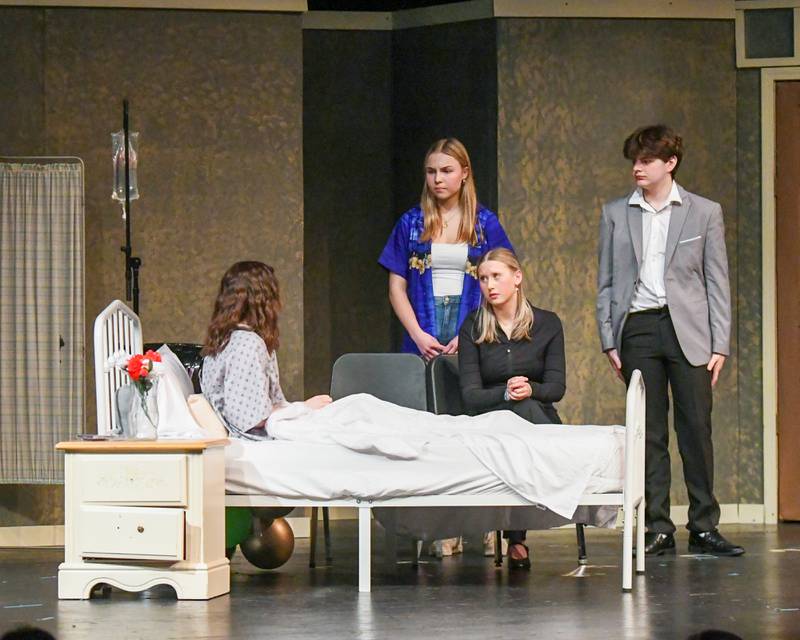 K.B. Noonan played by K.B. Noonan, left, Mr. Noonan played by Mia Wojcik, center, Karen Noonan played by Sophia Magajne, second from left, and Mr. Noonan played by Jackson V.K. talk during a one act scene of The Visitors on Saturday March 22, 2025, held at Lyons Township High School south campus.