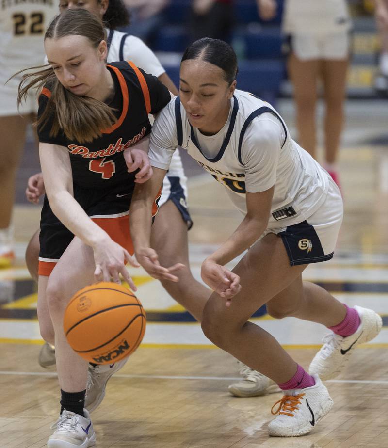Sterling’s Nia Harris and United Township’s Maycee Fitzpatrick go after a ball Thursday, Dec. 18, 2025.
