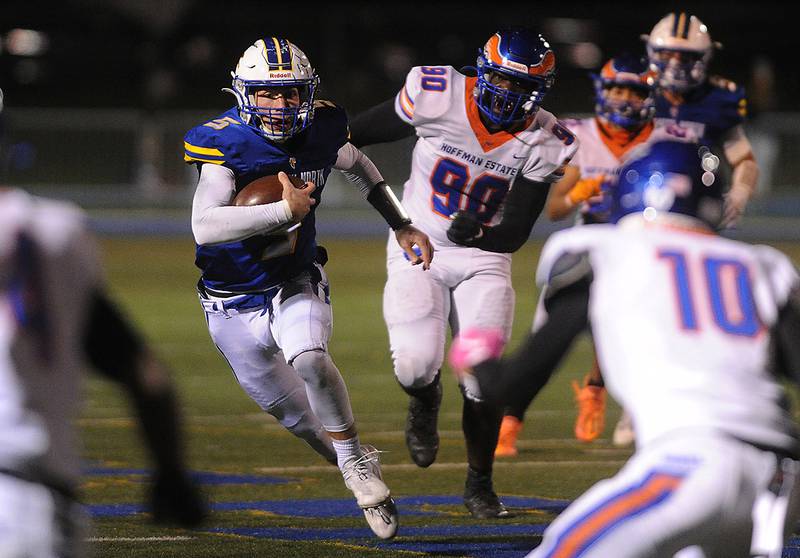 Wheaton North's quarterback Mark Forcucci winds his way through Hoffman Estates' defense late in the second quarter for yardage in the boys Class 7A football playoff game in Wheaton on Friday.