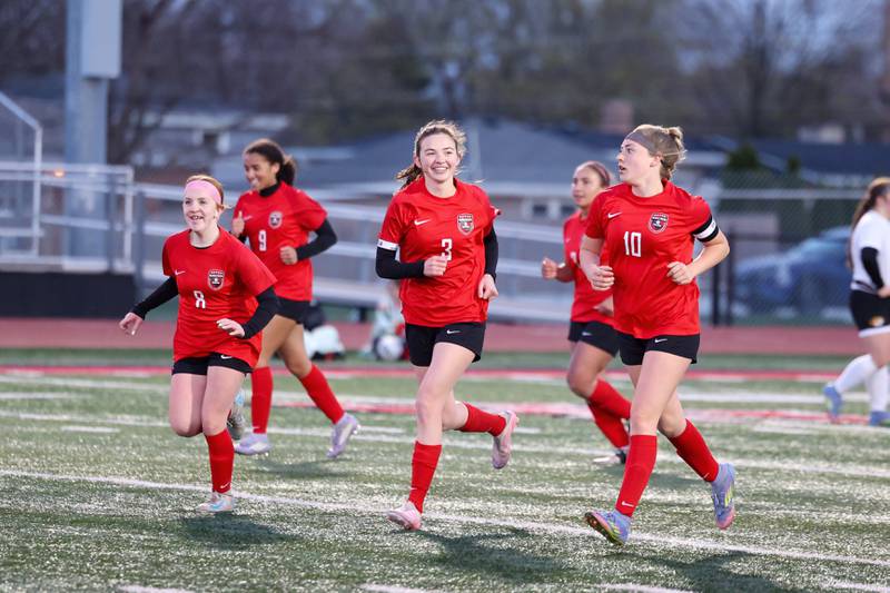 Bradley-Bourbonnais' Marti Grizzle, center, and Haven Frueling, left, smile after a goal by Harper Tollefson, right, during Bradley-Bourbonnais' 4-3 victory over Herscher on Monday, April 6, 2026.
