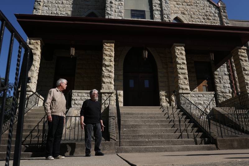 Mark Kroll, left, and Steve Kapella talks about the history of St. Peter Lutheran Church, in Joliet. The church will be holding a family game day fundraiser on October 15th to help recoup some of the quarter million dollar roof repairs.