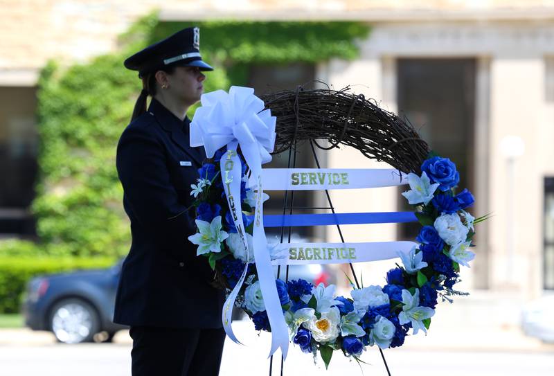 Kankakee Police Officer Samantha Fabbro stands near the memorial wreath during the Kankakee County Law Enforcement Memorial on Thursday, May 14, 2026, at the Kankakee County Courthouse.
