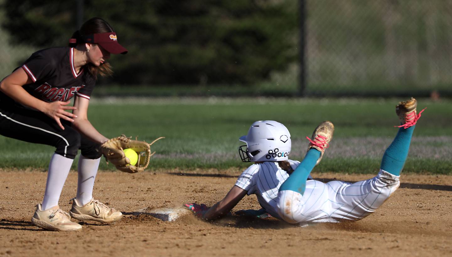 Richmond-Burton's Jocelyn Hird fields the throw as Woodstock North's Allyson Schaid slides into second base during a Kishwaukee River Conference softball game on Thursday, April 16, 2026, at Woodstock North High School.