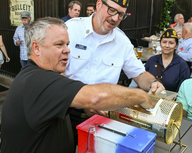 Mayor of St. Charles Clint Hull pulls the third-place winner of the 50/50 on Thursday Aug. 21, 2025, held at Whiskey Bend in St. Charles.