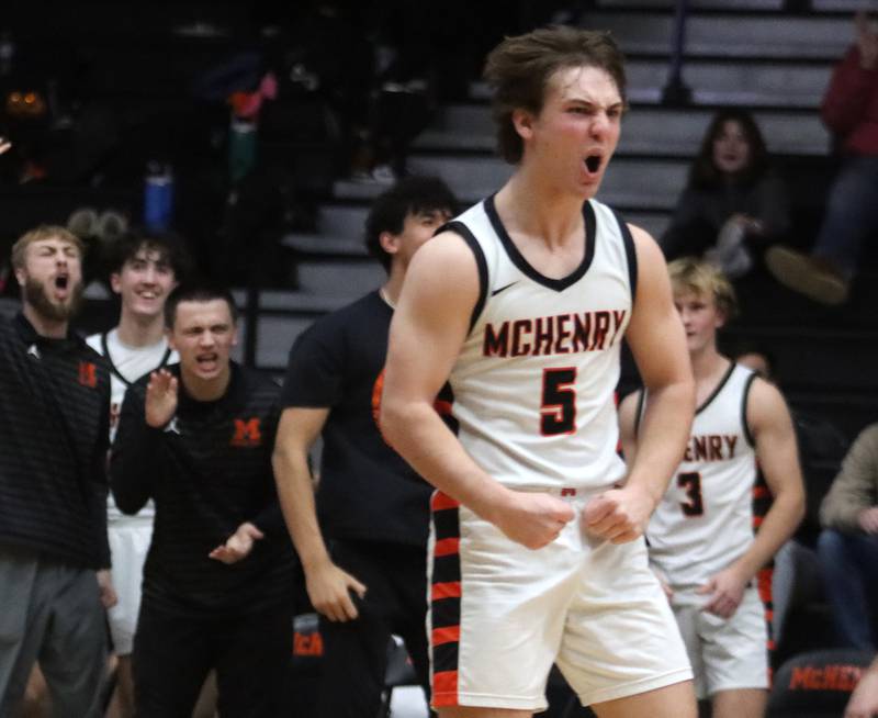 McHenry’s Kyle Maness reacts after a Caleb Jett three-point basket put the Warriors ahead for good in the OT period against Burlington Central in varsity boys basketball on Tuesday, Feb. 4, 2025, at  McHenry High School  in McHenry.
