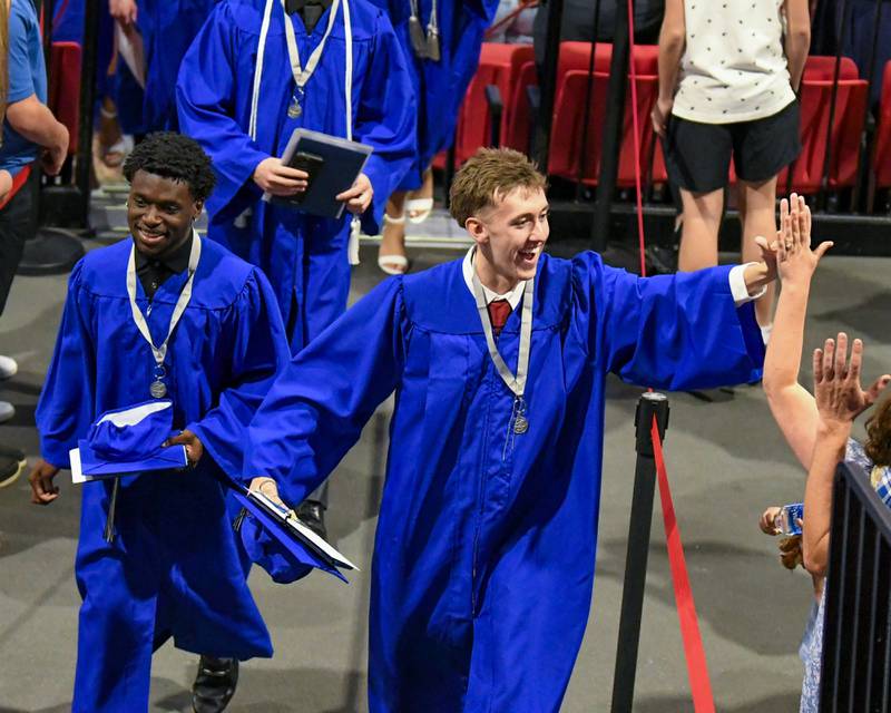 A St. Charles North graduate gets a high-five during the graduation recessional on Monday May 18, 2026, held at the NIU Convocation Center in DeKalb.