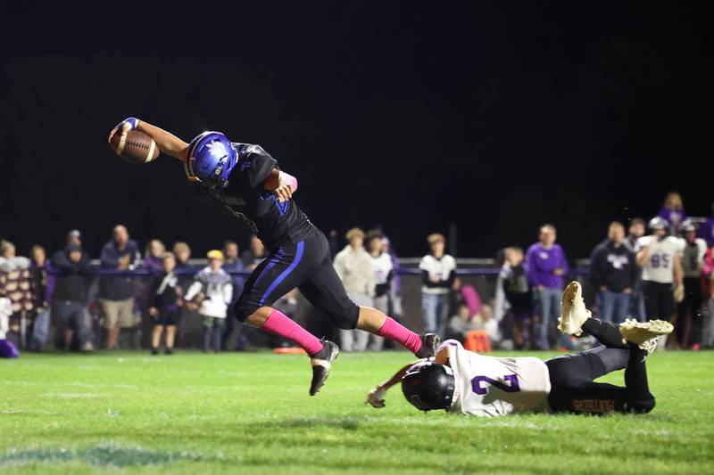 Peotone's Eli Chenoweth reaches in for a touchdown as Manteno's Dylan McIntyre attempts the tackle during the Blue Devils' 25-20 loss to Manteno on Friday, Oct. 17, 2025, in the annual Rumble on Route 50 rivalry game.