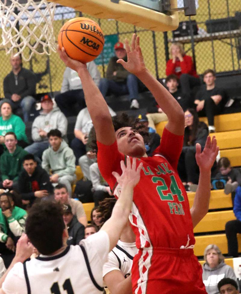 La Salle-Peru's Marion Persich shoots over Sycamore's Jake Shipley during their game Tuesday, Feb. 4, 2025, at Sycamore High School.